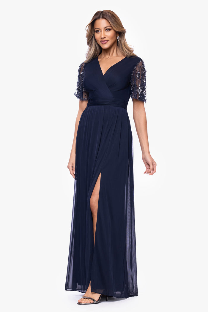 Navy “Aurelia” Sheer Matte Jersey Mesh Beaded Sleeve Dress, angled three-quarter view with side slit
