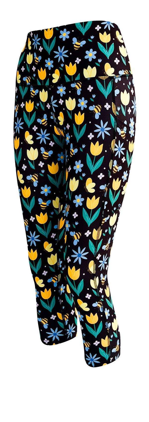 Black leggings with vibrant yellow tulips, blue and white flowers, and bumblebee pattern, featuring side pockets and high-rise waistband.