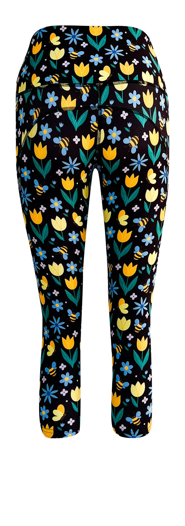 Black leggings with vibrant yellow tulips, blue forget-me-nots, white daisies, and bumblebee print, featuring deep side pockets and a high-rise waistband.