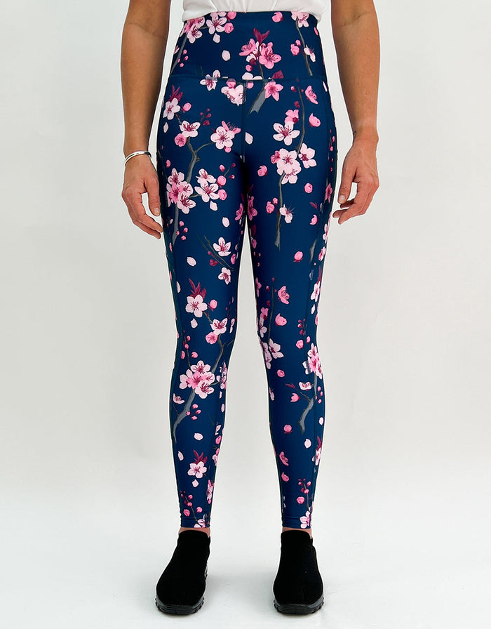 Women's navy blue leggings with pink cherry blossom print activewear and pockets