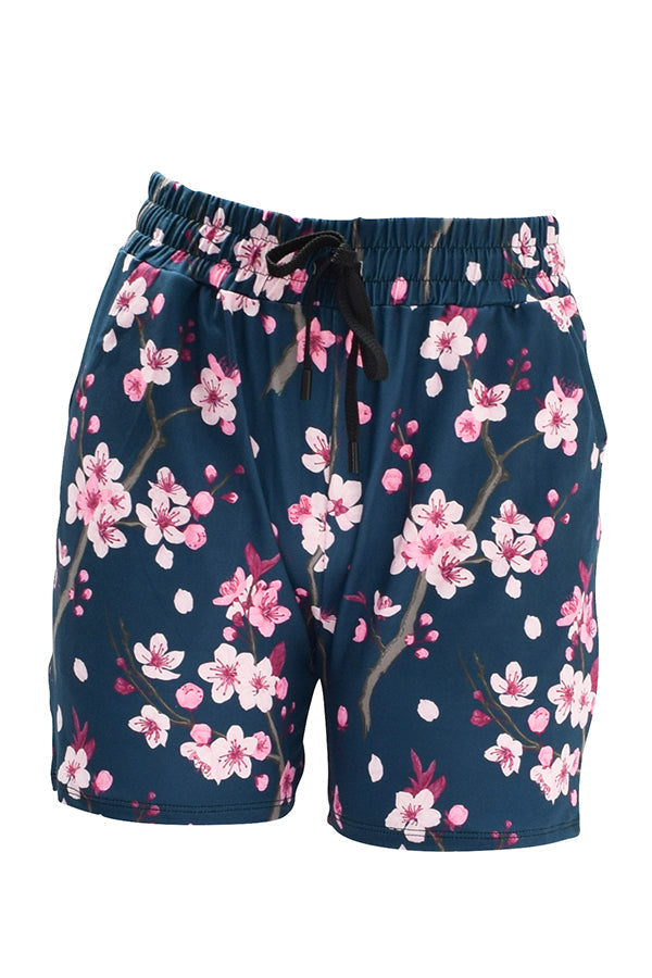 Slim fit cherry blossom jogger shorts with elastic waistband and drawstring on navy background