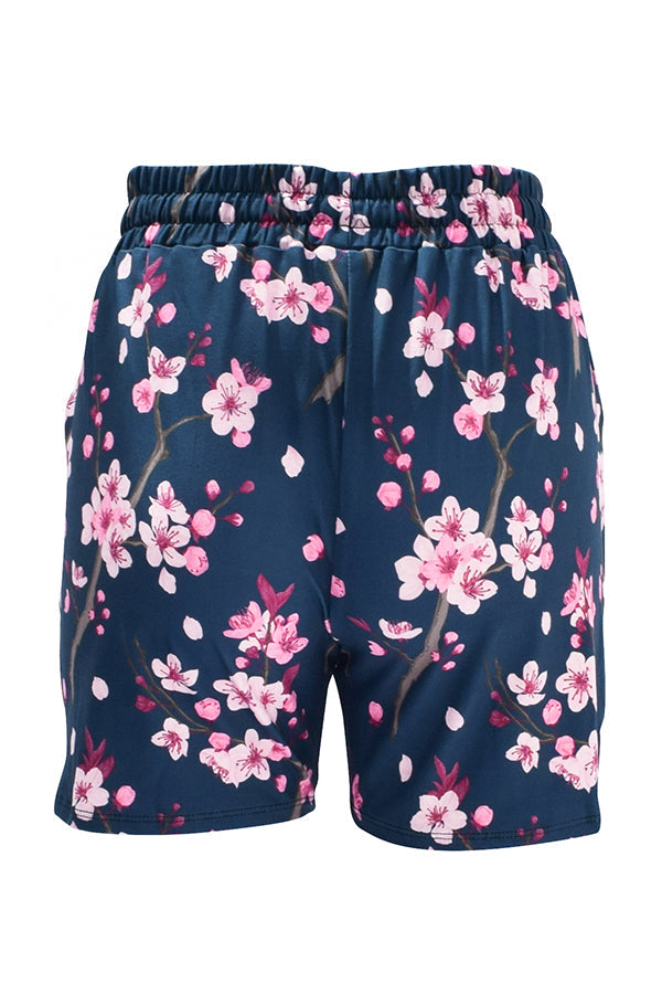 Navy jogger shorts with vibrant pink cherry blossom floral print and elastic waistband.