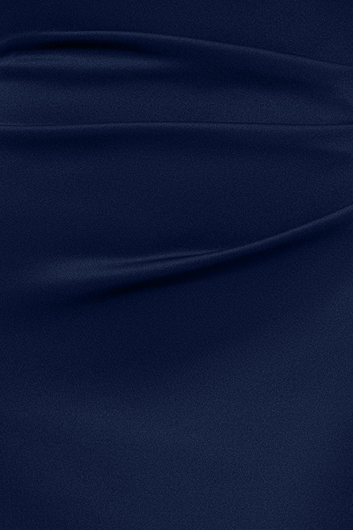 Close-up of the techno scuba fabric in midnight on the Dolly techno scuba off the shoulder ruffle dress.