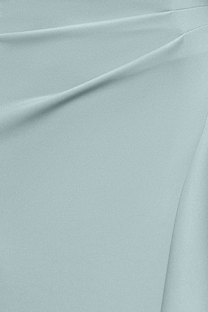 Close-up of the techno scuba fabric in sage on the Dolly techno scuba off the shoulder ruffle dress.
