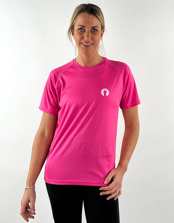 Woman wearing hot pink breathable active llama t-shirt with short sleeves and black leggings.