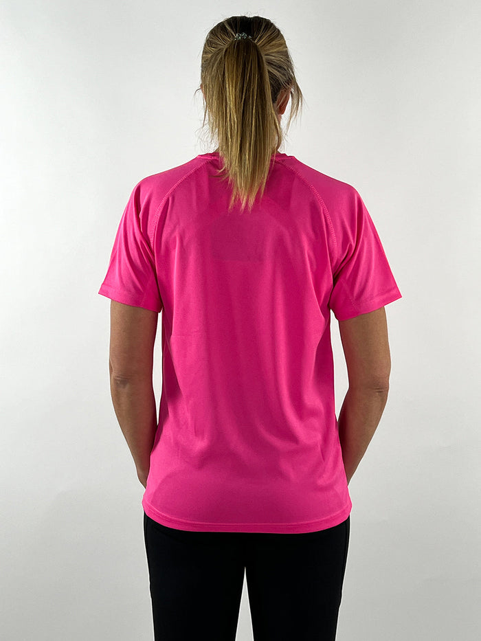 Back view of a woman wearing a hot pink lightweight active t-shirt paired with black workout leggings