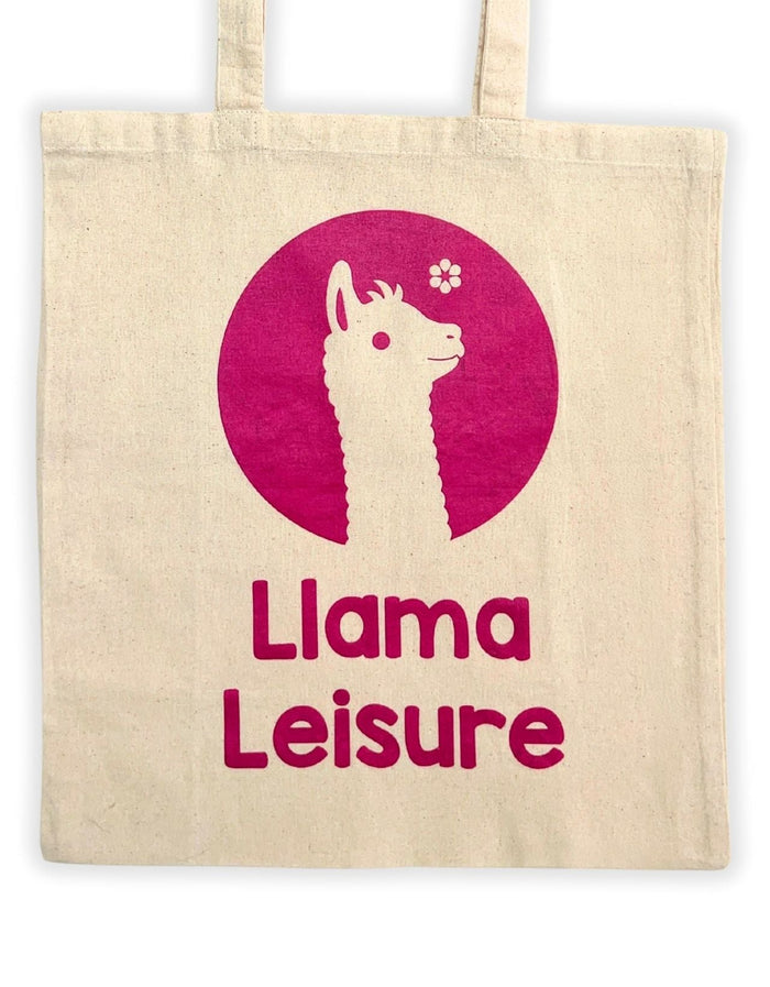 Beige tote bag with pink llama graphic and text "Llama Leisure" printed on front