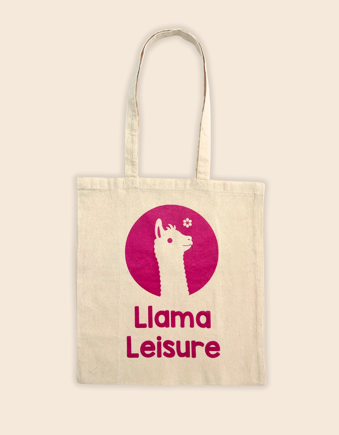 Llama tote bag with pink llama graphic and "Llama Leisure" text on beige canvas background