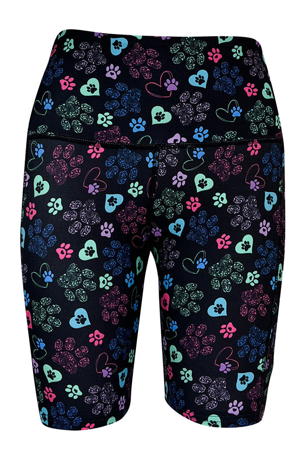 Magic Paws Shorts with colorful heart and paisley paw prints on black background and deep side pockets.