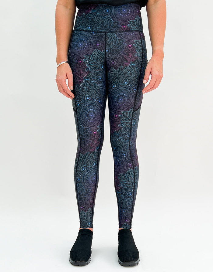 Woman wearing Midnight Mandala Activewear leggings with subtle mandala pattern and pockets.