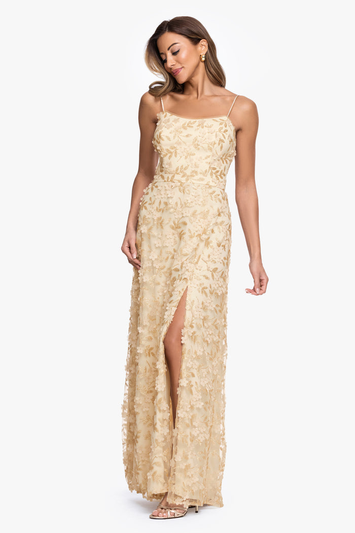 Gold “Natalie” Flower Embellished Spaghetti Strap Gown, angled three-quarter view with side slit
