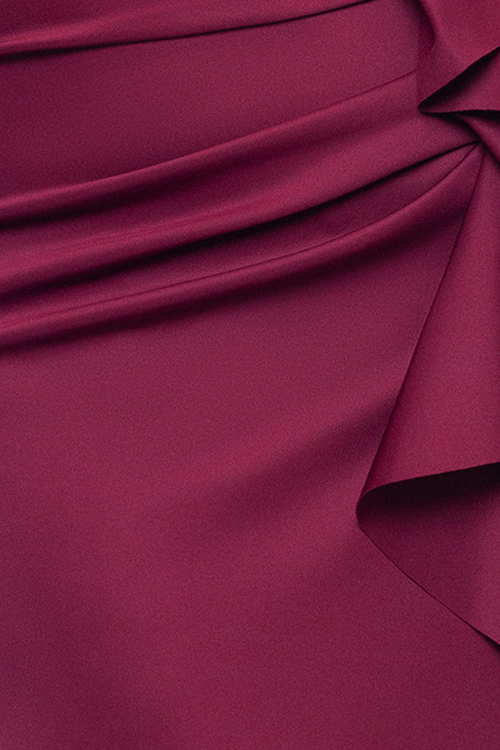 Close-up of the Wine techno scuba fabric, ruching, and ruffle on the Plus “Patti” Techno Scuba Off The Shoulder Dress