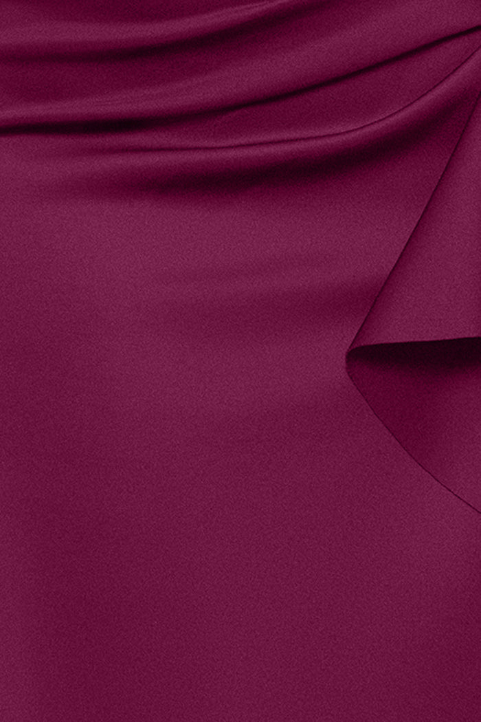 Close-up of the Raisin techno scuba fabric, ruching, and ruffle on the Plus “Patti” Techno Scuba Off The Shoulder Dress