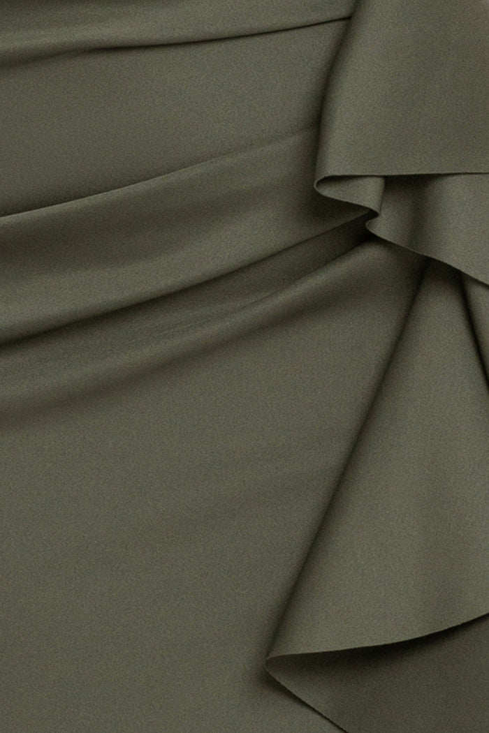 Close-up of the Olive techno scuba fabric, ruching, and ruffle on the Plus “Patti” Techno Scuba Off The Shoulder Dress