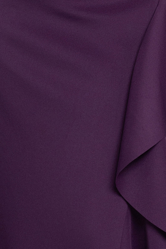 Close-up of the Plum techno scuba fabric and cascading ruffle on the Plus “Pearl” Techno Scuba Off the Shoulder Ruffle Dress