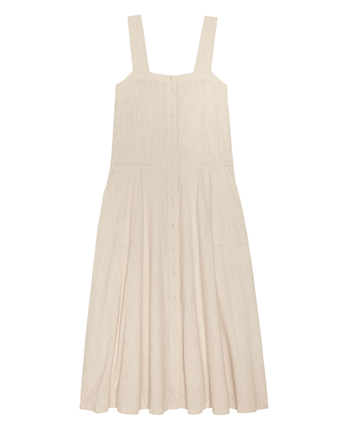 The Apron Dress by THE GREAT. SU26 in Natural features wide straps, a square neckline, button-down front, and flared skirt.