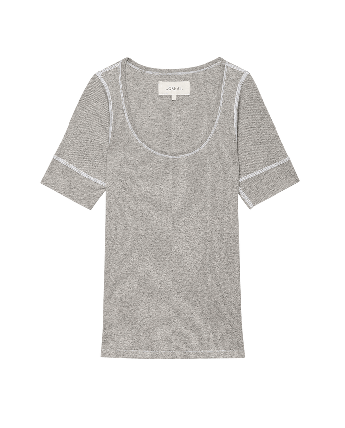 The Baby Rib Ballet Tee in heather grey by THE GREAT. SU25 BABY RIB features short sleeves, baby rib fabric, white stitching, and a scoop neckline, shown flat on a black background.