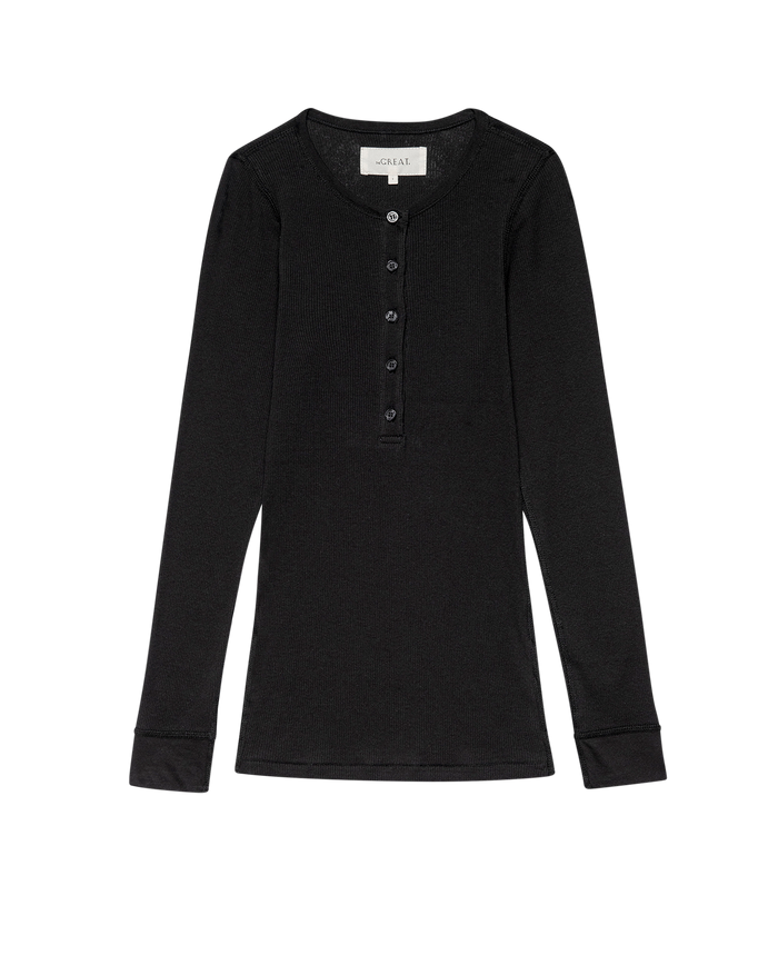 The Baby Rib Henley by THE GREAT. F25 BABY RIB in Almost Black is a vintage-inspired, ribbed long-sleeve with a buttoned placket, crafted from recycled cotton and shown laid flat on a white background.