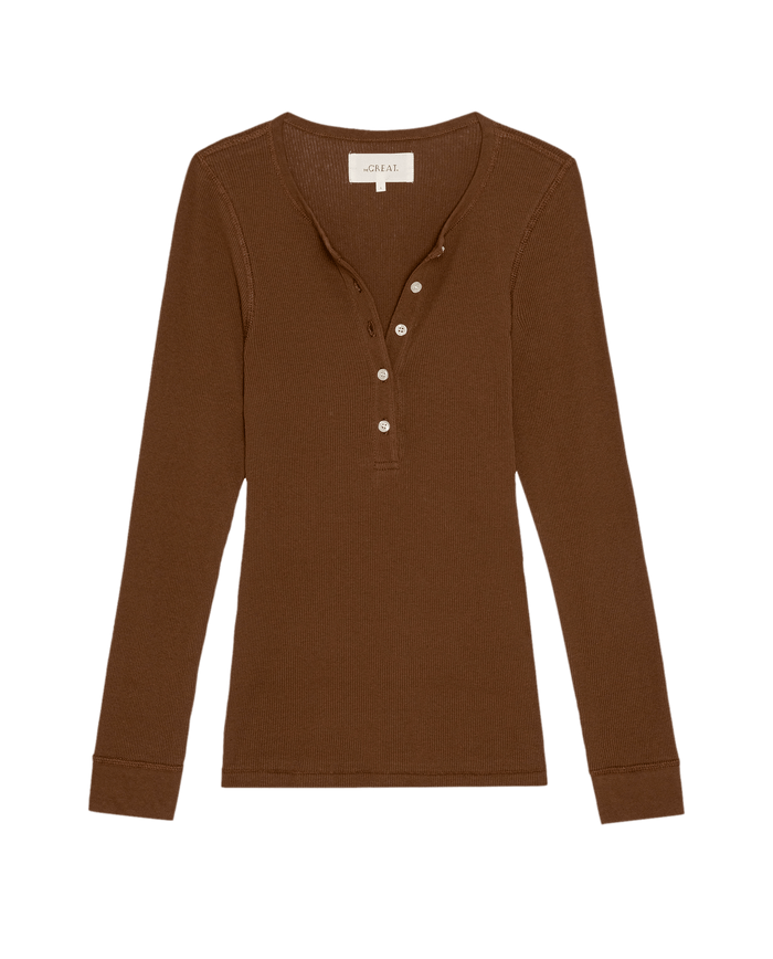 The Baby Rib Henley in Chocolate by THE GREAT. PF26 RIB KNITS is a vintage-inspired slim rib knit in recycled cotton blend, with long sleeves, partial button placket, and round neckline, shown flat on a white background.
