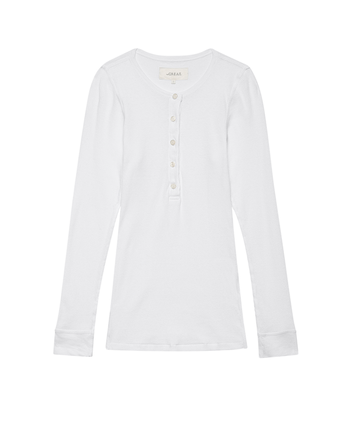 The Baby Rib Henley in True White by THE GREAT. F25 BABY RIB, features a vintage-inspired design with long sleeves, a round neckline, and a five-button placket, crafted from a recycled cotton blend and laid flat on a white background.