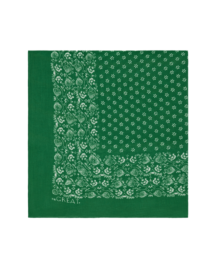 The Big Bandana. -- Bright Sprig by THE GREAT. SP26 D1 is a green vintage-style bandana with white paisley and floral print, “the GREAT.” text at the corner; perfect as a scarf or accessory.