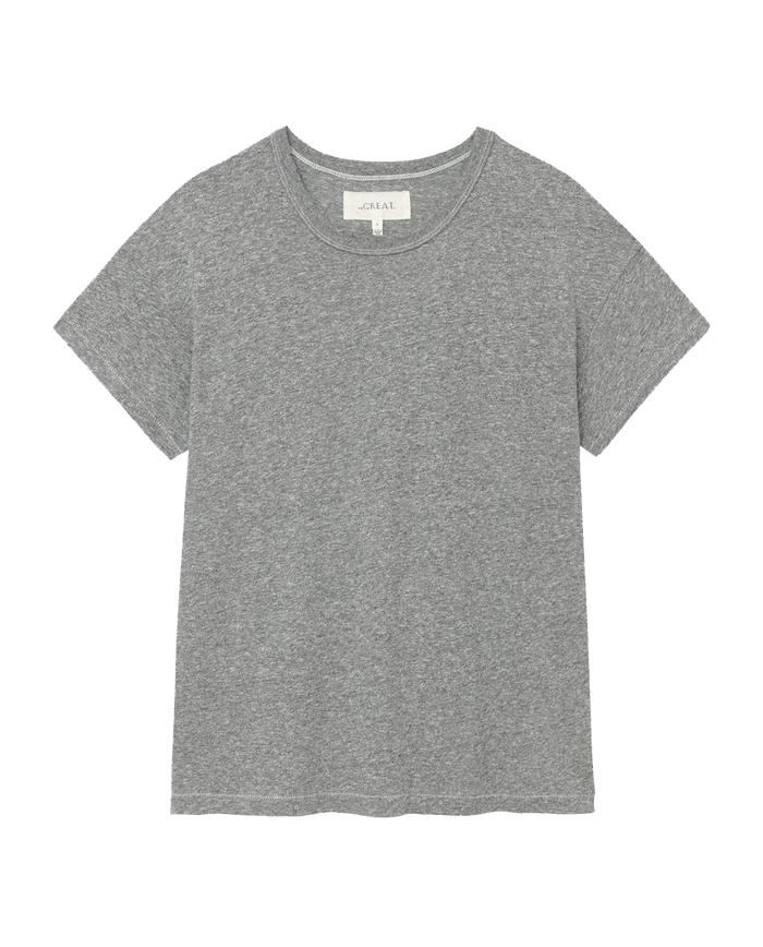 A heather grey, short-sleeved T-shirt from THE GREAT. CORE KNITS, known as The Boxy Crew, laid flat and reminiscent of classic vintage tees made in the U.S.A.