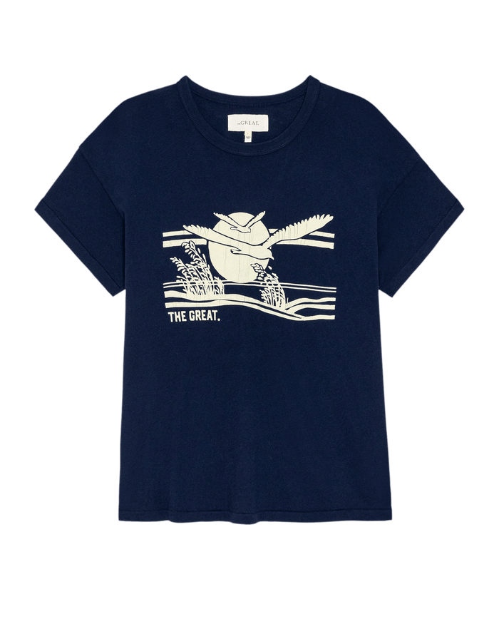 The Boxy Crew w/ Everglade Graphic by THE GREAT. PF26 in True Navy features a bird flying over water and reeds with "THE GREAT." below, offering handcrafted Los Angeles style in a vintage, boxy fit.