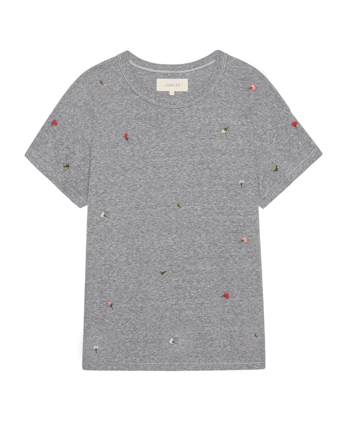 The Boxy Crew W/ Tossed Floral Emb. by THE GREAT. SU26 is a handcrafted heather grey short-sleeve tee with colorful embroidered floral details scattered on the front.