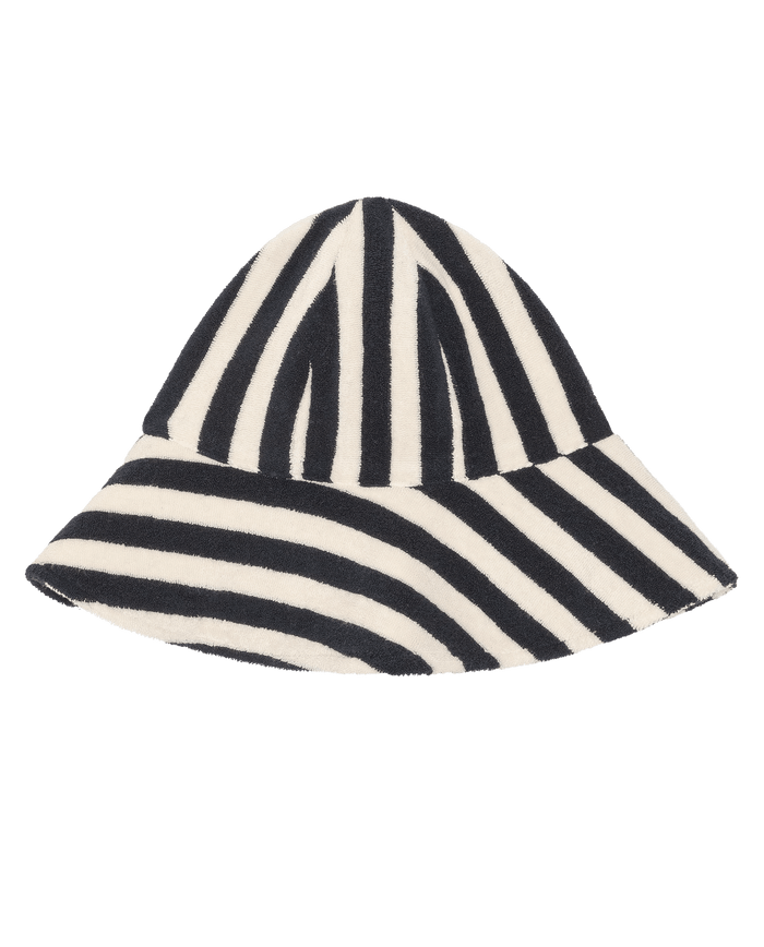 The Bucket Hat by THE GREAT. SU26 in Navy Shoreside Stripe features wide alternating diagonal and vertical navy-and-white stripes, shown on a plain white background.