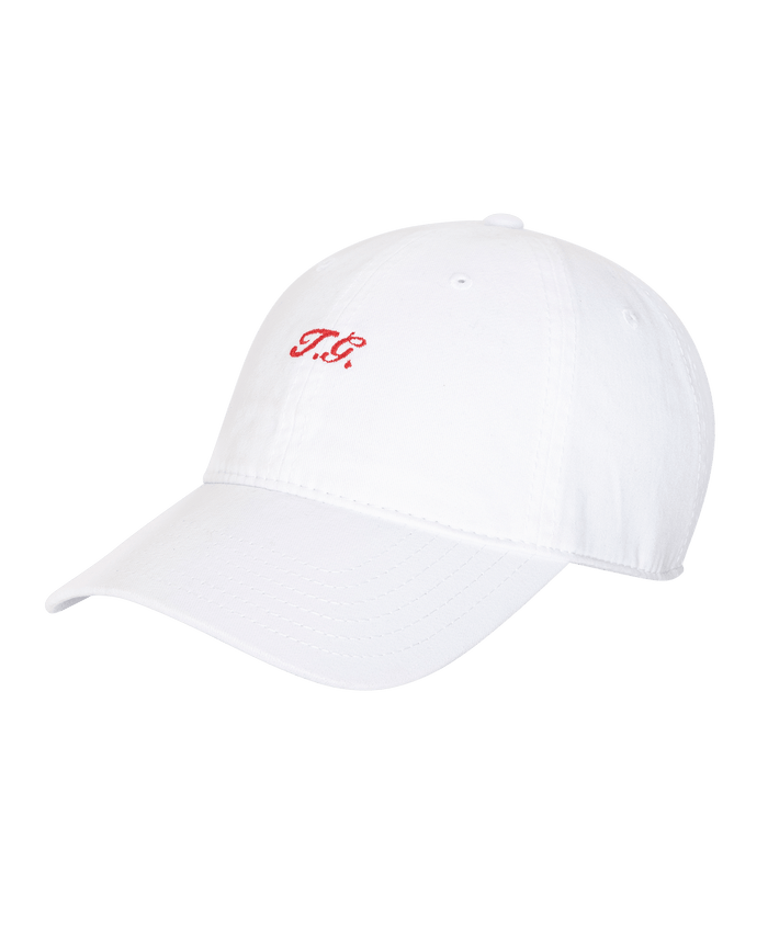 The Baseball Hat in white by THE GREAT. SU26 features a classic curved brim and small red embroidered "TB" initials on the front.