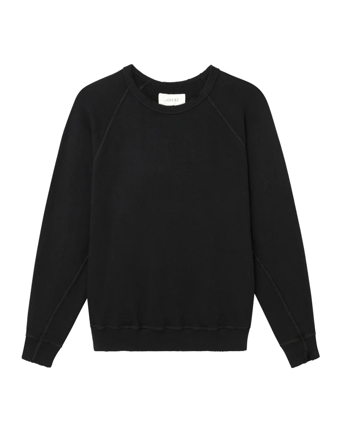 The College Sweatshirt by THE GREAT. CORE KNITS in Solid -- Almost Black features a plain long-sleeved design with ribbed cuffs, a crew neckline, and an oversized, relaxed fit.