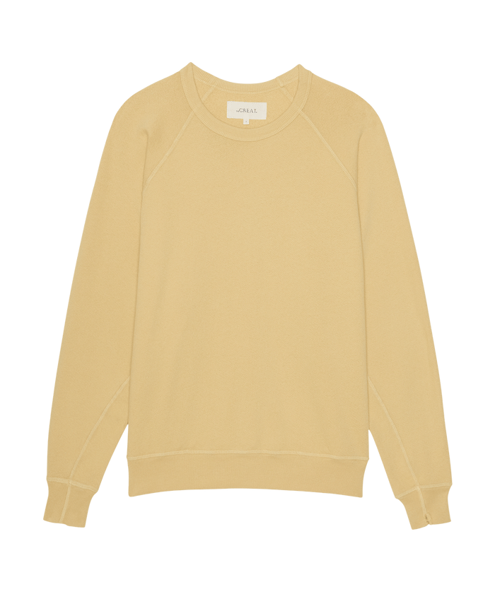 The College Sweatshirt in Butter Yellow by THE GREAT. SP26 SEASONAL CORE is a plain, long-sleeved, oversized style laid flat on a white background.