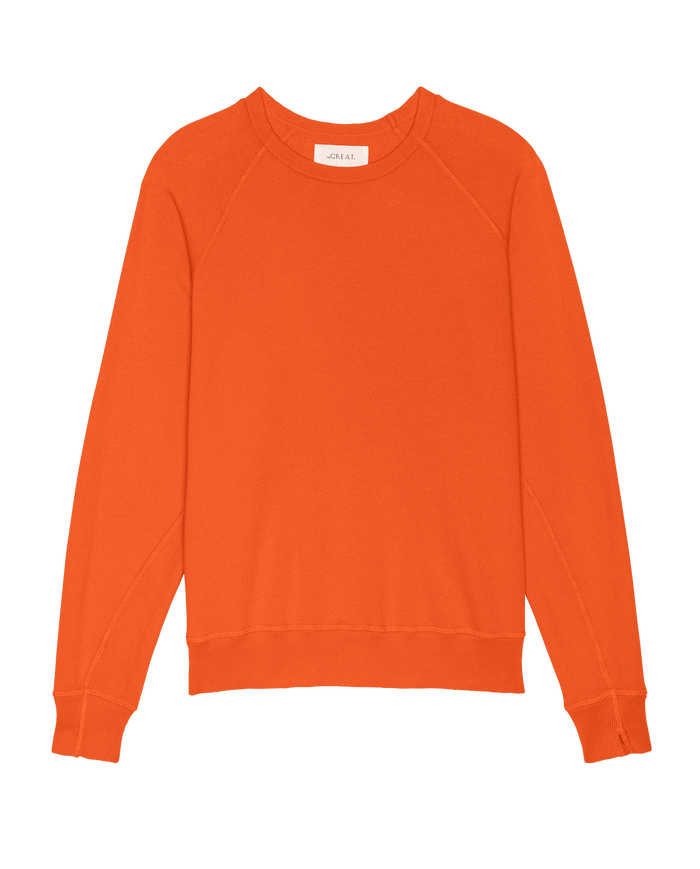 The College Sweatshirt in Persimmon by THE GREAT. SP26 SEASONAL CORE is an oversized, handcrafted long sleeve style made in Los Angeles, shown on a white background.