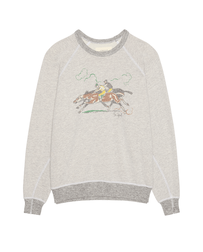 THE GREAT. PF26 The College Sweatshirt w/ Derby Graphic in Soft Heather Grey features a crewneck style with darker gray cuffs and collar, double washed terry fabric, and a front graphic of two jockeys riding horses.