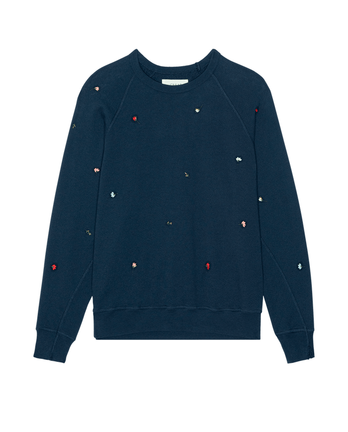 THE GREAT. PS26 College Sweatshirt W/ Tossed Floral Emb. in navy features small, multicolored embroidered flowers scattered across the front and sleeves for a vintage crewneck look.
