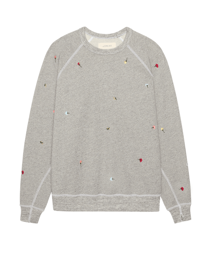 The College Sweatshirt W/ Tossed Floral Emb. by THE GREAT. SU26 in Varsity Grey is an oversized LA-made vintage style, subtly embroidered with colorful floral motifs throughout.