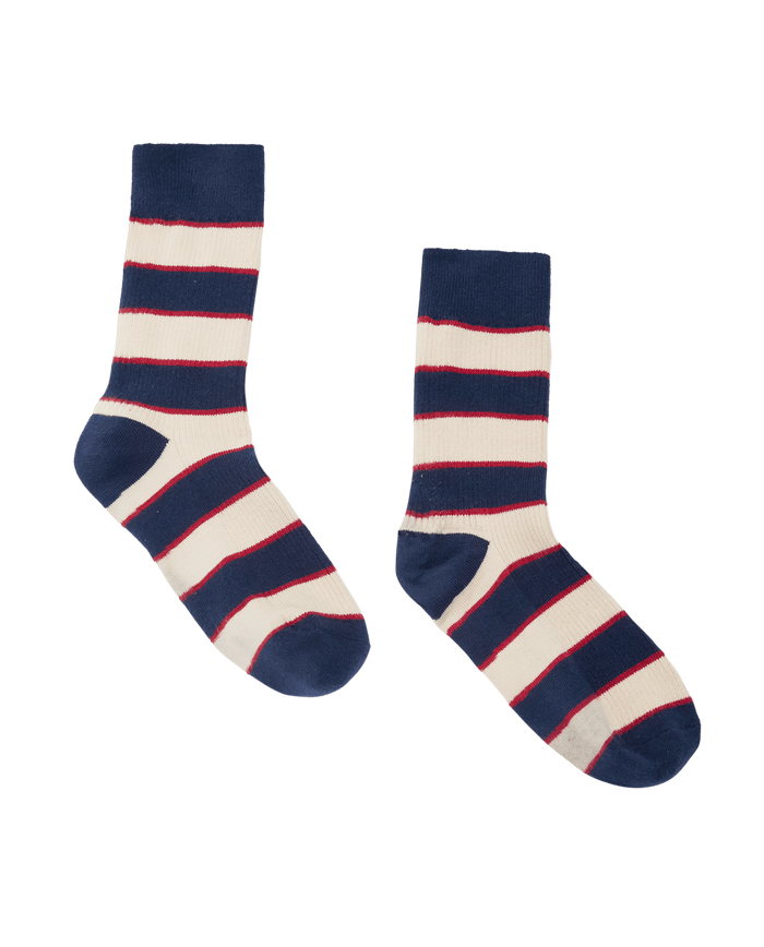 The Collegiate Sock. -- Navy by THE GREAT. F26 D1, a pair of collegiate crew socks featuring horizontal navy blue, red, and white stripes, displayed on a plain white background.