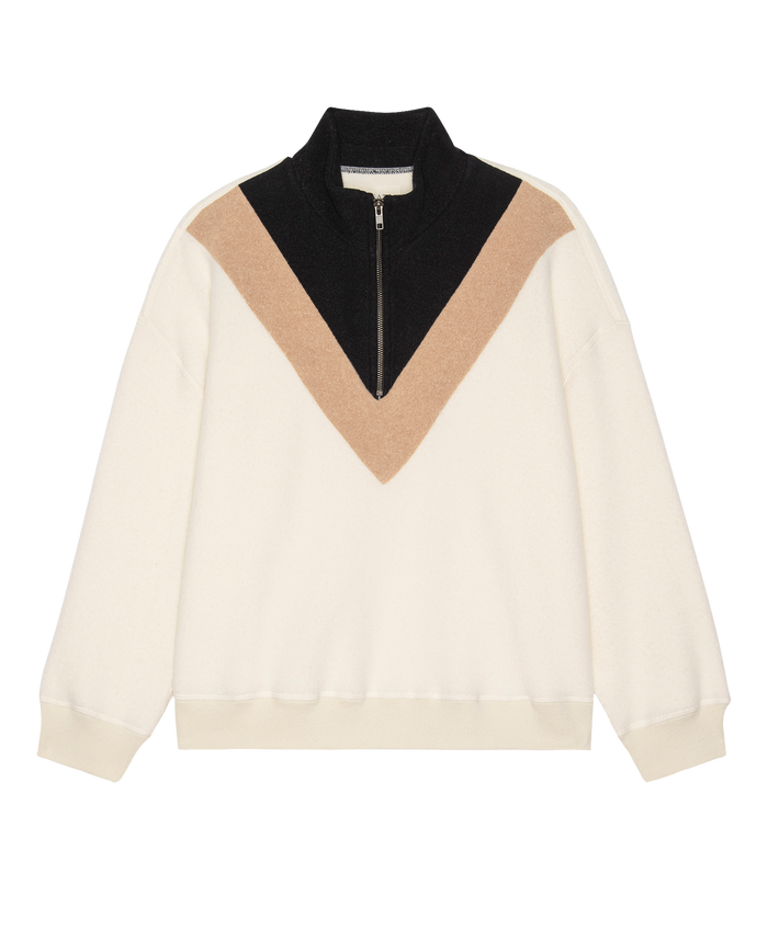 The GREAT. H25 TEDDY FLEECE Colorblock Plush Chalet Sweatshirt in Washed White features a black half-zip collar, tan and black V-shaped chest design, and a slouchy silhouette in ultra-soft fleece for cozy comfort.
