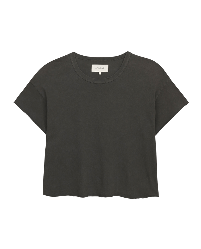 The Crop Tee in Washed Black by THE GREAT. CORE KNITS features a super soft, short-sleeve, crewneck design against a plain white background.