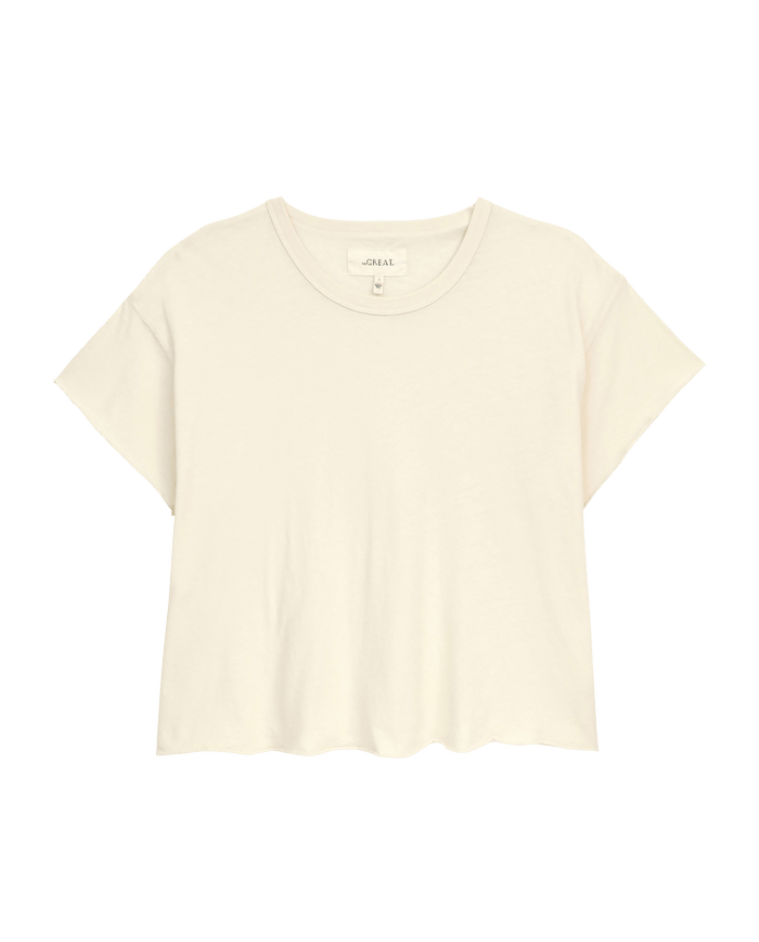 The Crop Tee by THE GREAT. CORE KNITS is a super soft, solid washed white T-shirt featuring short sleeves and a round neckline.