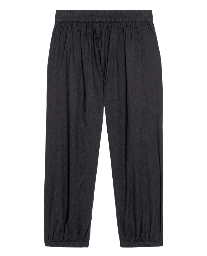 THE GREAT. SU26 The Elastic Blouson Pant in black features a loose fit, elastic waistband, and cuffed hems, shown flat on a white background.