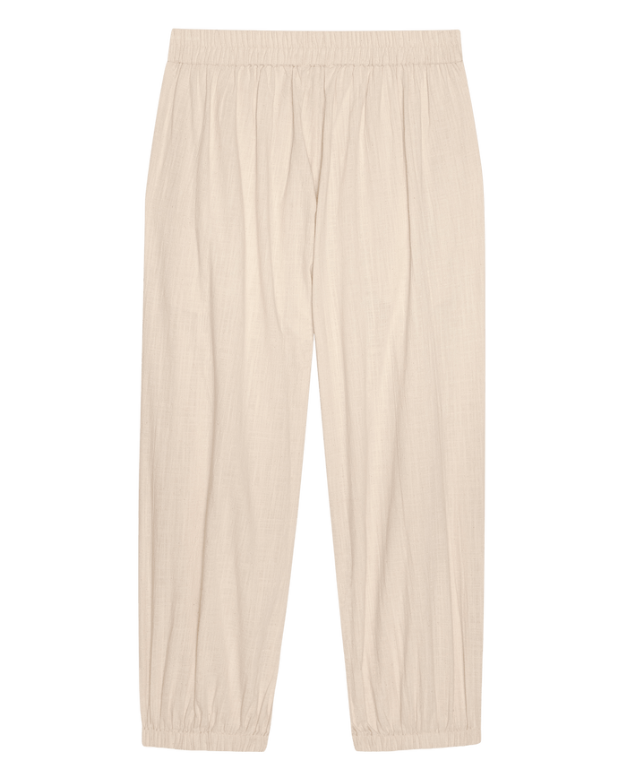 THE GREAT. SU26 The Elastic Blouson Pant in Natural: lightweight, straight-leg pants with elastic waistband and cuffs, shown laid flat on a white background.