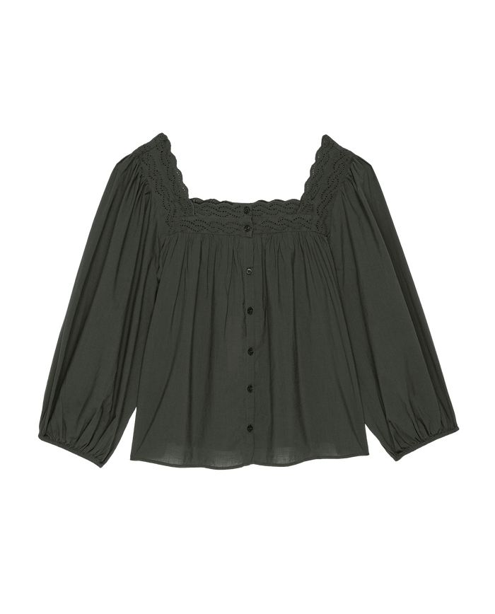 The Eyelet Button Sleep Top in black by THE GREAT. PS25 SLEEP is a dark green, long-sleeved blouse made from soft cotton voile, adorned with Victorian-inspired lace trim and eyelet buttons down the front.