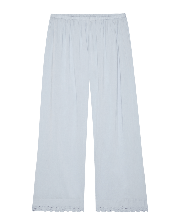 The Eyelet Easy Sleep Pant in Rainwater by The Great. SP26 Sleep—light blue cotton voile wide-leg pants with elastic waist and Victorian eyelet lace trim at the hem, shown flat on a white background.