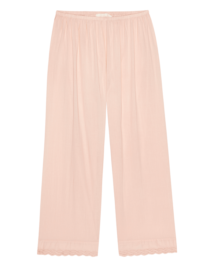 The Eyelet Easy Sleep Pant by THE GREAT. F26 SLEEP in Washed Rose, featuring a light pink hue, wide-leg silhouette, elastic waistband, and lace trim at the hem, displayed flat on a white background.