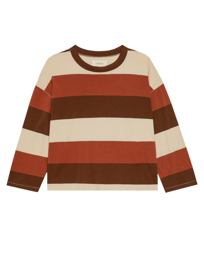 The Field Tee—Ashwood Stripe by THE GREAT. PF26 is a long-sleeve tee with wide cream, brown, and rust stripes, shown laid flat on a white background.