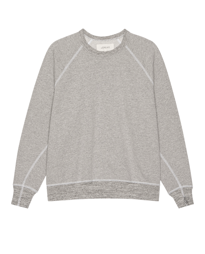 The Fleece College Sweatshirt by THE GREAT. H25 CORE FLEECEBACK, in heather grey, features long sleeves and visible stitching, shown laid flat on a white background.