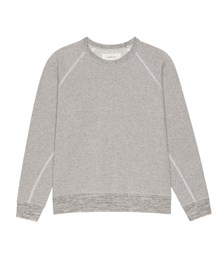 The Fleece Rookie Sweatshirt by THE GREAT. H25 CORE FLEECEBACK in heather grey, featuring ribbed cuffs, collar, and hem, is shown laid flat on a white background.