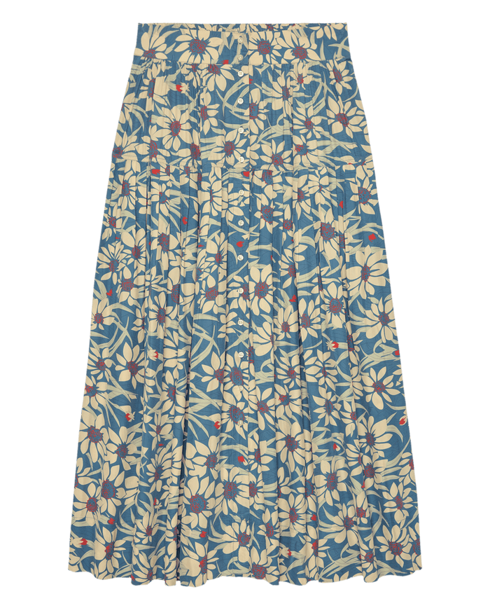 The Highland Skirt – Blue Scattered Bloom by THE GREAT. SP26 D2 is a high-waisted pleated skirt with a blue background, cream blossoms, red accents, and classic Highland-inspired detailing.