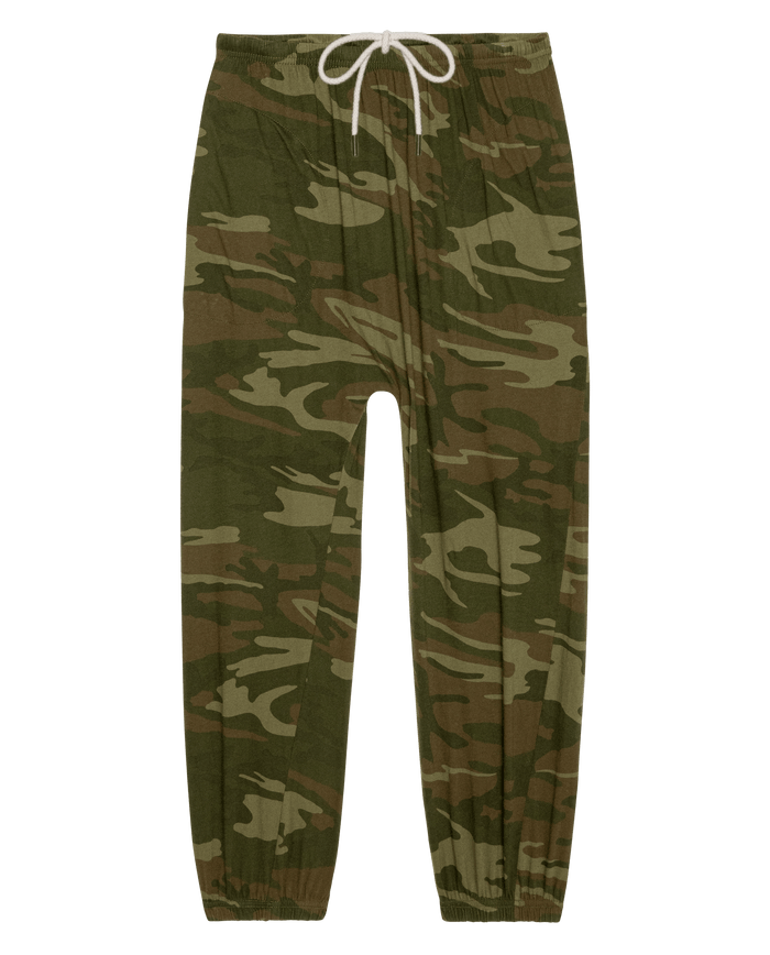 The Jersey Jogger Pant in Deep Woods Camo by THE GREAT. SU26 features a green and brown camouflage print, elastic waistband with white drawstring, and elastic cuffs.